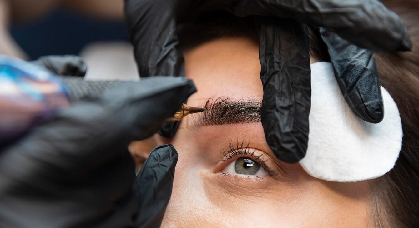 young-woman-getting-beauty-treatment-her-eyebrows young-woman-getting-beauty-treatment-her-eyebrows
